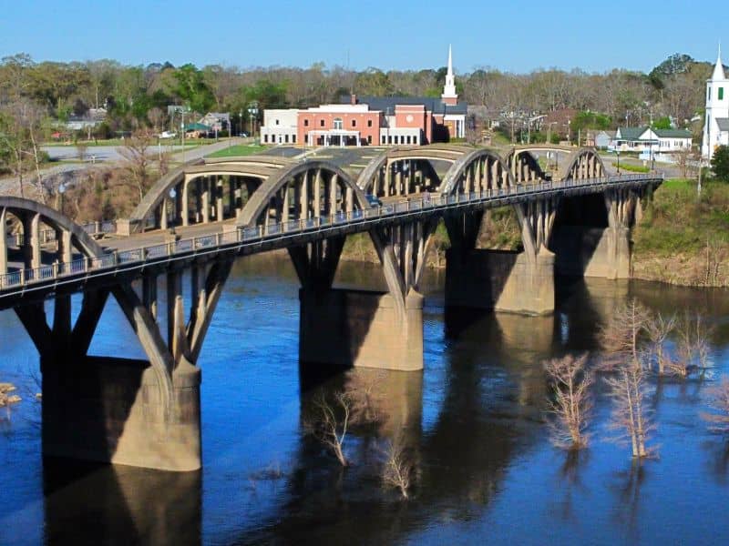 Historic bridge crossing the Coosa River in Wetumpka, Alabama near residential and commercial areas relevant to land surveying and property development